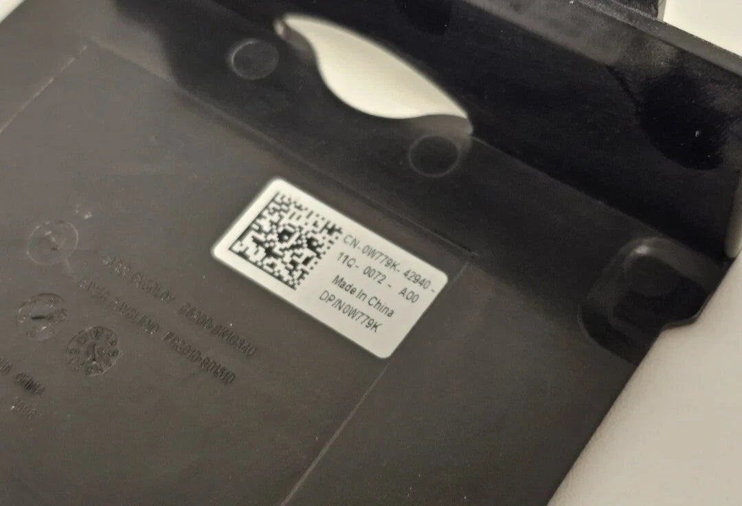 QR code label on a black surface with visible text