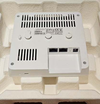Electronic device with ports and labels on a beige background