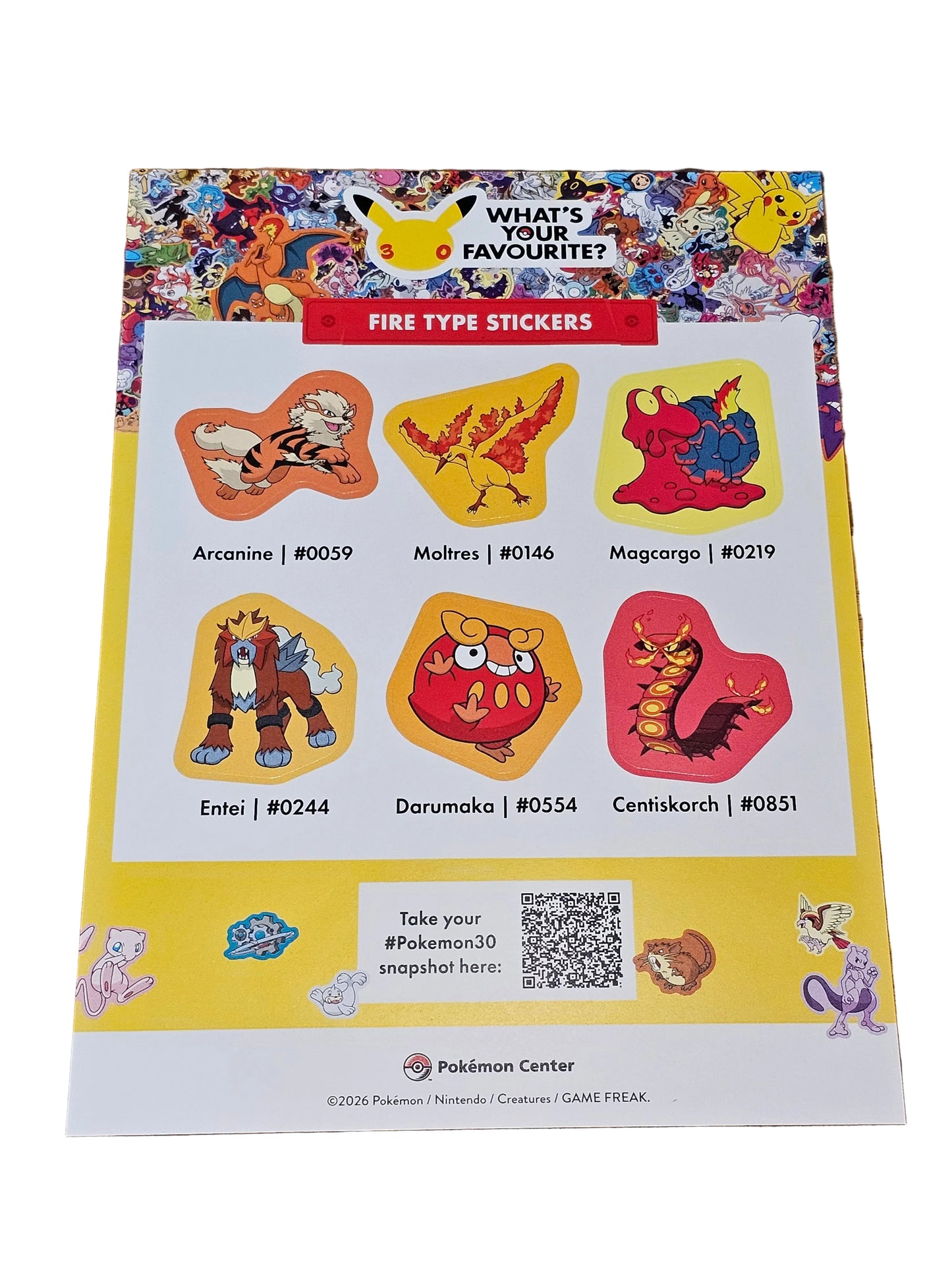 Sheet of colorful stickers on a wooden surface
