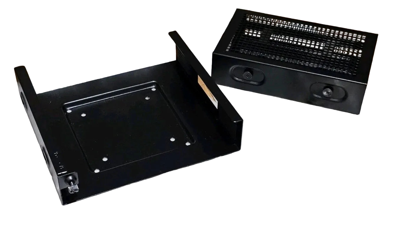 Black computer case components on a wooden surface with packaging and manuals.