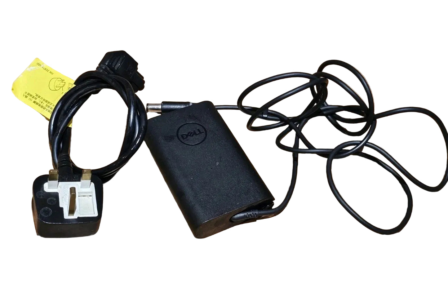 Black Dell power adapter with cable on a wooden surface